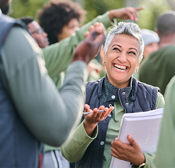 a happy older woman talking to a man